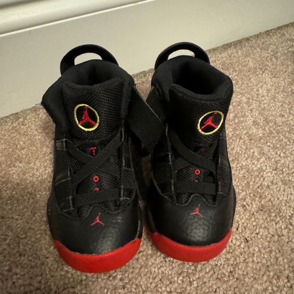 Black, red, and gold Jordans